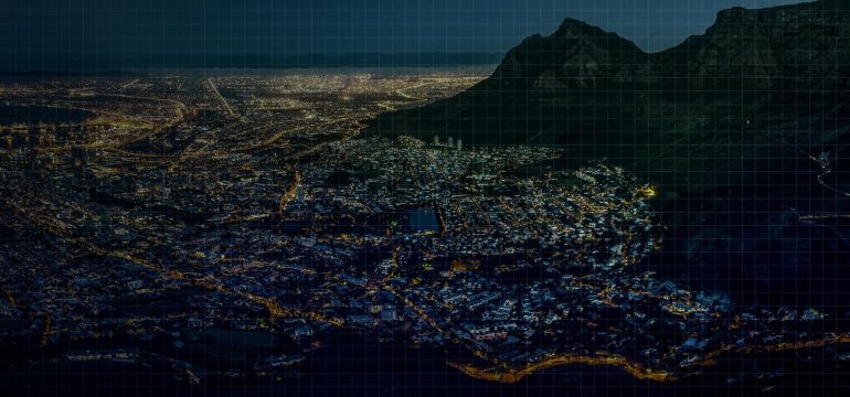 Nighttime aerial view of Cape Town with a digital grid overlay.